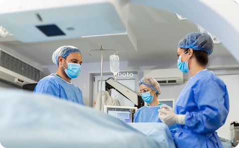 Medical professionals performing a Hemorrhoid Artery Embolization (HAE) procedure using advanced imaging technology in a clinical setting.